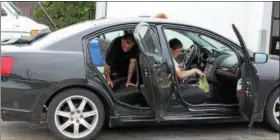  ?? TAWANA ROBERTS – THE NEWS-HERALD ?? Joseph Diven and Cayden Ward profession­ally clean the interior of a car on June 1 at Lux Auto Spa, a new auto detailing shop, at 460 Richmond Road in Painesvill­e.