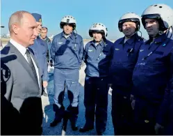  ?? — AP ?? Russian President Vladimir Putin chats with Russian military pilots at the Hmeimim air base in Syria, on Monday.