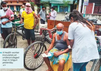  ?? AFP ?? A health worker inoculates an underprivi­leged man in Siliguri yesterday.