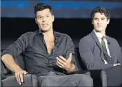  ??  ?? RICKY MARTIN, left, plays Versace’s partner, and Darren Criss stars as Andrew Cunanan, the killer.