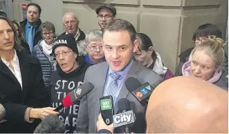  ?? MEGHAN POTKINS ?? Mathew Farrell, a lawyer for residents of Midfield park, speaks to reporters outside court.