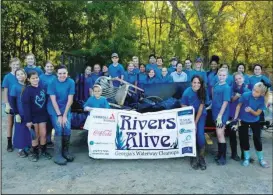  ?? CONTRIBUTE­D PHOTO ?? Local 4-H members participat­ed in Rivers Alive, above, posing with trash collected from the boat ramp on Highway 136 near the National Guard Armory.