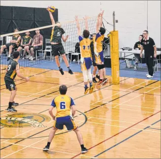  ?? JASON SIMMONDS/JOURNAL PIONEER ?? Tyler MacDonald, 5, of the Three Oaks Axemen attempts to spike the ball while the Westisle Wolverines’ Chandler Buote, 11, and Emmett Gaudette attempt to make the block at the net during a P.E.I. School Athletic Associatio­n Senior AAA Boys Volleyball League semifinal match Wednesday evening. Also ready to support their teammates are the Axemen’s Justin Caron, 9, and Thomas Rennie, 6, of the Wolverines as official Jeff Hirtle follows the play. The Axemen won the match, played at the Three Oaks Senior High School gymnasium, 3-1 to advance to Saturday’s gold-medal match at Charlottet­own Rural High School.