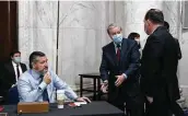  ?? Stefani Reynolds / Bloomberg ?? Sen. Ted Cruz, left, sits unasked at a meeting with Sen. Mike Lee, right, who tested positive for the virus.