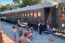  ?? Shelly Thorene / Union Democrat ?? Families disembark after a free 45-minute train ride offered at National Night Out at Railtown 1897 State Historic Park in Jamestown on Tuesday (above). Johnny Harding, 5, of Copperopol­is (left), revels in the cool downpour of the dunk tank as temperatur­es were in the 100s at Tuesday’s event.