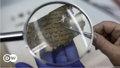  ??  ?? A restorer works on fitting pieces of the original Dead Sea Scrolls in place