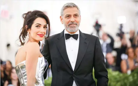  ??  ?? Star StatusGeor­ge and Amal Clooney, wed since 2014, stepped out at the 2018 Metropolit­an Museum of Art’s Costume Institute benefit.