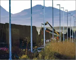  ?? MATT YORK — THE ASSOCIATED PRESS ?? Crews construct a section of President Donald Trump’s new border wall in San Bernardino National Wildlife Refuge earlier this month in Douglas, Ariz.