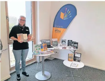  ?? FOTO: JOHANNA WARSZAWA ?? Bettina Schüren, Leiterin der Meerbusche­r Stadtbibil­iothek, und ihre Kollegen haben für jedes Alter und Bedürfnis einen Buch- oder Zeitschrif­tentipp.