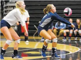  ?? STAFF PHOTO BY ERIN O. SMITH ?? Walker Valley’s Alice Woolson digs the ball as Hannah Grace Moore backs her up during a District 5-AAA volleyball semifinal match Monday against Ooltewah at Bradley Central High School. Walker Valley won 3-0.