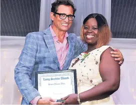  ??  ?? Kyle Mais, general manager, Jamaica Inn, presents an award to 16-year employee Lorraine Duncan-Davis.
