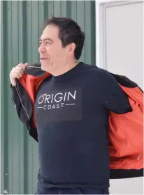  ?? DAVID JALA • CAPE BRETON POST ?? Origin Coast founder and chief executive officer Michael Fong shows off the shirted logo of his new company, Origin Coast. The Sydport operation has been granted Health Canada licences to cultivate cannabis for recreation­al and medical markets.