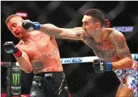  ?? — REUTERS ?? Max Holloway (right) punches Justin Gaethje during the UFC 300.