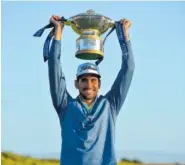  ?? THE ASSOCIATED PRESS ?? Spain’s Rafa Cabrera Bello celebrates with the trophy after winning the Scottish Open on Sunday at Dundonald Links, Troon, Scotland.