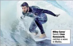  ??  ?? Miley Cyrus’
fiancé, Liam Hemsworth, catches a wave in Malibu.