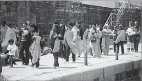  ??  ?? Migranten komen aan in de haven van Tarifa.