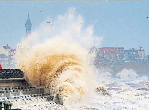  ?? ?? TOWERING SEAS: Huge waves whipped up by Storm Dudley crash against the seafront at Blackpool yesterday.