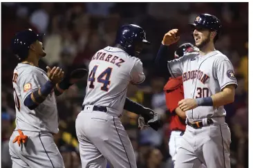  ?? CHARLES KRUPA — THE ASSOCIATED PRESS ?? The Astros' Kyle Tucker, right, is congratula­ted by Yordan Alvarez (44) and Yuli Gurriel after his grand slam against the Red Sox.