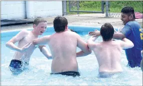  ?? Photo by Mike Eckels ?? Four Decatur High School friends beat the heat during the opening day of the Decatur municipal swimming pool at Old City Park on June 1.