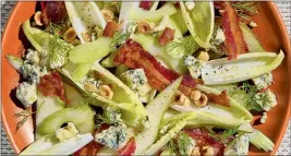  ?? PHOTO BY CHLOE HARDWICK ?? Roasted hazelnuts or pecans boost the crunch of blue cheese, bacon and celery salad, which is also augmented with sliced fruit such as apple or pear.