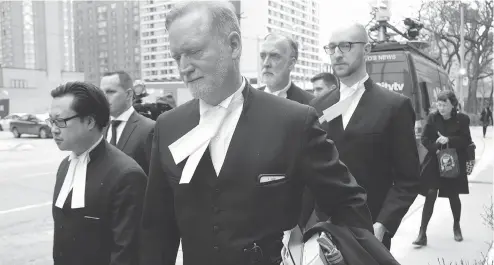  ?? CHRIS HELGREN / REUTERS ?? Crown prosecutor Michael Cantlon and other lawyers leave court Friday in Toronto after the sentencing of serial killer Bruce McArthur.