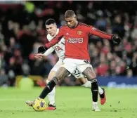  ?? Picture: CATHERINE IVILL/GETTY IMAGES ?? MY BALL: Marcus Rashford of Manchester United controls the ball as he is challenged by Pedro Porro of Tottenham Hotspur during their English Premier League match at the weekend