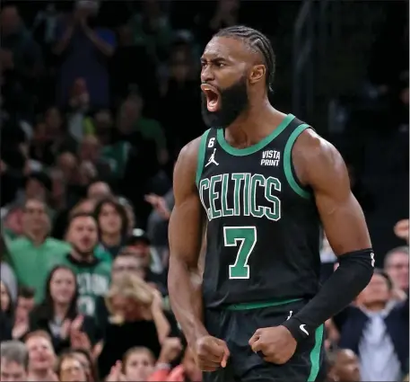  ?? STUART CAHILL — BOSTON HERALD ?? Boston Celtics star Jaylen Brown screams after sinking a 3-pointer as the Celtics defeated the Timberwolv­es earlier this season. Brown is enjoying a career season and headed to the All-Star game.