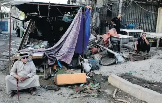  ?? Hadi Mizban/the Associated Press ?? The aftermath of a car-bomb attack at a store at the Karrada neighbourh­ood of Baghdad, Iraq.