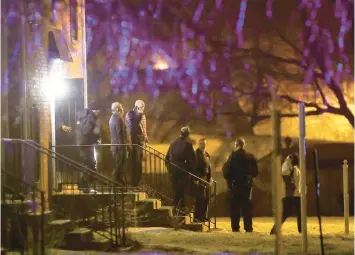  ?? GRACE HOLLARS/AP ?? Officers walk out of the apartment complex where four people, one woman and three men, were found dead in Indianapol­is, on Feb. 5, 2020. Three Indianapol­is men have been convicted in the case.