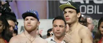  ??  ?? Canelo Alvarez (left) and Julio Cesar Chavez Jr. pose for photograph­ers during a weigh-in Friday in Las Vegas. AP PHOTO