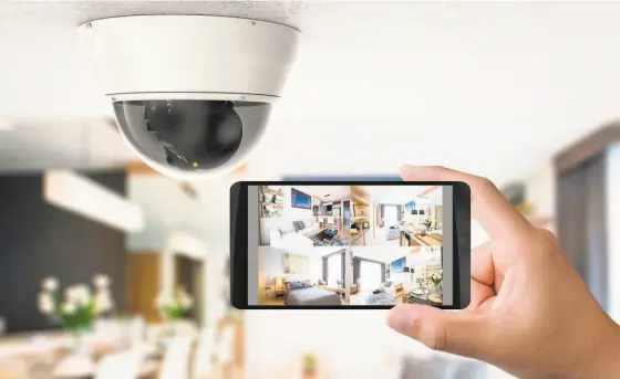  ?? Shuttersto­ck ?? Above: Smarthome security systems that connect to local emergency responders can save you money on your homeowner’s insurance. Below: Smarthome security systems can be controlled by a smartphone or tablet.