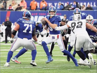  ?? Bill Kostroun / Associated Press ?? New York Giants quarterbac­k Daniel Jones scrambles away from Las Vegas Raiders defensive end Solomon Thomas during the second half on Nov. 7.