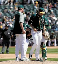  ?? Carlos Avila Gonzalez / The Chronicle ?? Andrew Triggs is pulled in the fifth inning by manager Bob Melvin (left) during the A’s 11-1 loss to the Seattle Mariners.