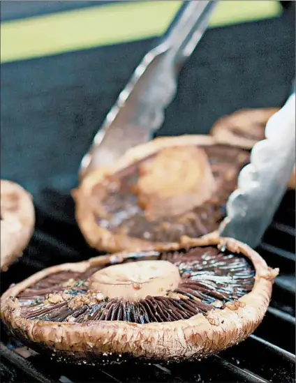  ?? DREAMSTIME ?? Grill the portobello mushroom “buns” until golden, turning only once.