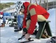  ?? LISA RATHKE — THE ASSOCIATED PRESS ?? In this photo, skaters put on skates in front of Lake Morey Resort in Fairlee, Vt., before heading out on the ice. The lake has a 4.5-mile Nordic skating trail that is said to be the longest in the United States.