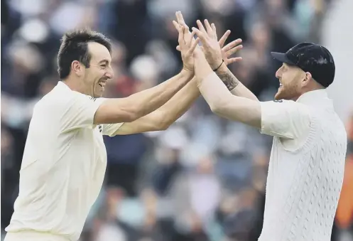  ??  ?? Toby Roland-jones, left, celebrates with Ben Stokes after dismissing Heino Kuhn, one of his four victims on the second day at The Oval.