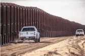  ??  ?? TOP: Two Border Patrol vehicles patrol the wall on Wednesday near Santa Teresa.