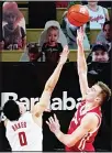  ??  ?? Wisconsin’s Tyler Wahl (right), shoots over Rutgers’ Geo Baker during the second half of an NCAA college basketball game, on Jan 15, in Piscataway, NJ. (AP)