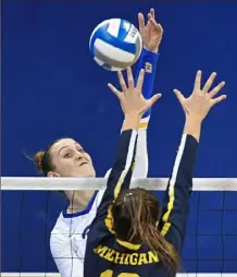  ??  ?? Pitt’s Nika Markovic spikes on Michigan’s Carly Skjodt.