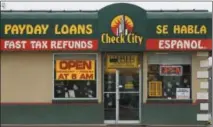  ?? LEAH HOGSTEN - THE ASSOCIATED PRESS ?? This undated photo shows a sign for Check City, which offers payday loans, in Salt Lake City. Americans take out roughly $50 billion in payday loans a year, each racking up hundreds of dollars in fees and interest.