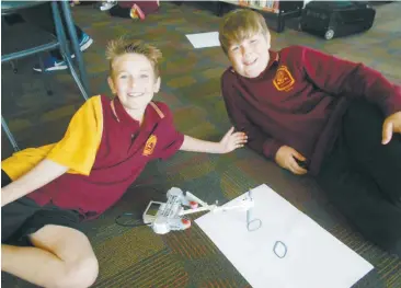  ??  ?? Cam Caddy and Brodie Baltruscha­itis enjoying their Bricks4Kid­s robotics session