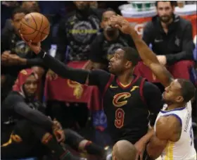  ?? TIM PHILLIS - THE NEWS-HERALD ?? Dwyane Wade soars toward the basket past the Warriors’ Andre Iguodala on Jan. 15.