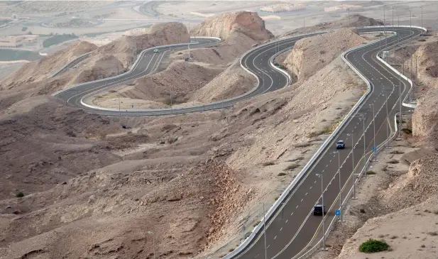  ??  ?? LONG AND WINDING... The road to the peak of Jebel Hafeet, where one can view the whole city of Al Ain, was built in 1980. The 11.7 km road has 60 turns and three lanes, two ascending and one descending.