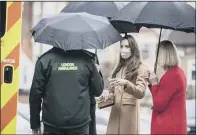  ??  ?? FAMILY CHAT: The Duke and Duchess of Cambridge talk with the family of paramedic Jay Khan via a mobile phone, top, on a visit to Newham Ambulance Station in east London; the Royal couple also heard about the mental health support on offer to staff.