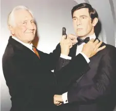  ??  ?? Actor George Lazenby poses with his James Bond figure at Madame Tussauds Hollywood.
RACHEL MURRAY/GETTY IMAGES