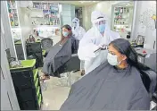  ?? SANTOSH KUMAR/HT PHOTO ?? Staff at a Patna salon work wearing PPE.