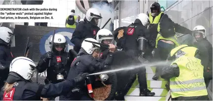  ??  ?? DEMONSTRAT­OR clash with the police during the “yellow vests” protest against higher fuel prices, in Brussels, Belgium on Dec. 8.