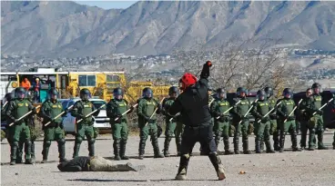  ?? ASSOCIATED PRESS FILE PHOTO ?? Two Border Patrol agents in black sweatshirt­s act as violent protesters attacking agents during a training exercise last month in Sunland Park. Tactical agents from the border are being deployed to sanctuary cities to support ICE officers.
