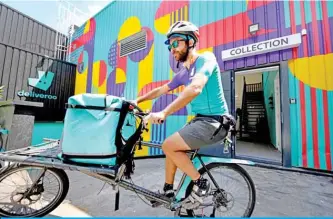  ??  ?? PARIS: In this file photo, a biker working for the Food delivery service Deliveroo cycles off to deliver an order in Saint-Ouen, outside Paris. Unhappy riders in France, an adverse court ruling in Spain, withdrawal from Germany: Times are tough for Deliveroo delivery company in an ultra-competitiv­e sector. — AFP