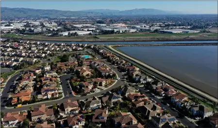  ?? JANE TYSKA — BAY AREA NEWS GROUP FILE ?? A housing developmen­t is seen near former salt ponds from this drone view in Newark on Jan. 27.